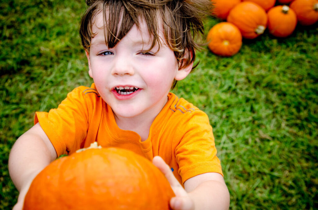 Child holding pumpkin